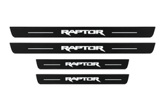 Catalog illustration of two front and two rear black Matte PRO door sill plates with RAPTOR lettering and horizontal lines illuminated on top; opaque unlit side edges. Final dimensions selected for Ford Ranger T6 during manufacture.