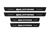 Catalog illustration of two front and two rear black Matte PRO door sill plates with WILDTRAK lettering and horizontal lines illuminated on top; opaque unlit side edges. Final dimensions selected for Ford Ranger T6 during manufacture.