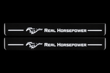 Product visualization: two flat Real Horsepower and Pony Stainless front plates, exact original own artwork. Black night background, unlit stainless face nearly hidden, white illuminated artwork, bars and real side/end edges with soft glow.