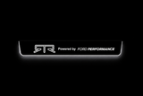 Product visualization: RTR Powered by Ford Performance, single plate as exact source flat brushed stainless steel door sill plates with white LED artwork and edges, dark background.