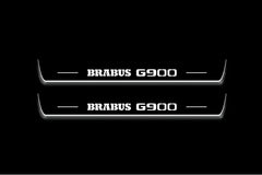 Two long door sill plates with Brabus G900 lettering and edges illuminated in white, straight-on view on a dark background.