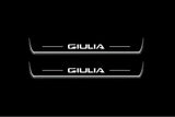 Two short door sill plates with Giulia lettering and edges illuminated in white, straight-on view on a dark background.