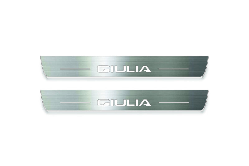 Two short silver-finished door sill plates with Giulia lettering on a light background, straight-on view.