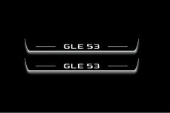 Two long door sill plates with GLE 53 lettering and edges illuminated in white, straight-on view on a dark background.