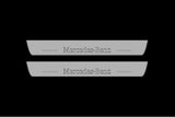 Catalog illustration of two short gray door sill plates with Mercedes-Benz lettering and linear slots.