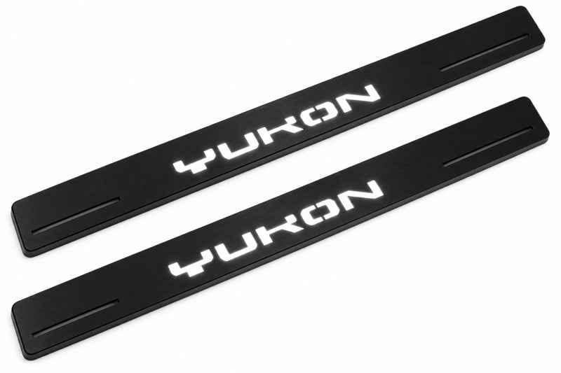 Catalogue illustration of two front black Matte PRO LED door sill plates with illuminated Yukon lettering for GMC Yukon V; dimensions are selected during manufacture.