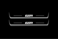 Two long door sill plates with GSR lettering and edges illuminated in white, straight-on view on a dark background.