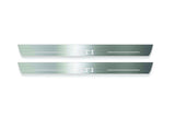 Two long silver-finished door sill plates with GTI lettering on a light background, straight-on view.