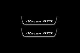 Two short door sill plates with Macan GTS lettering and edges illuminated in white, straight-on view on a dark background.