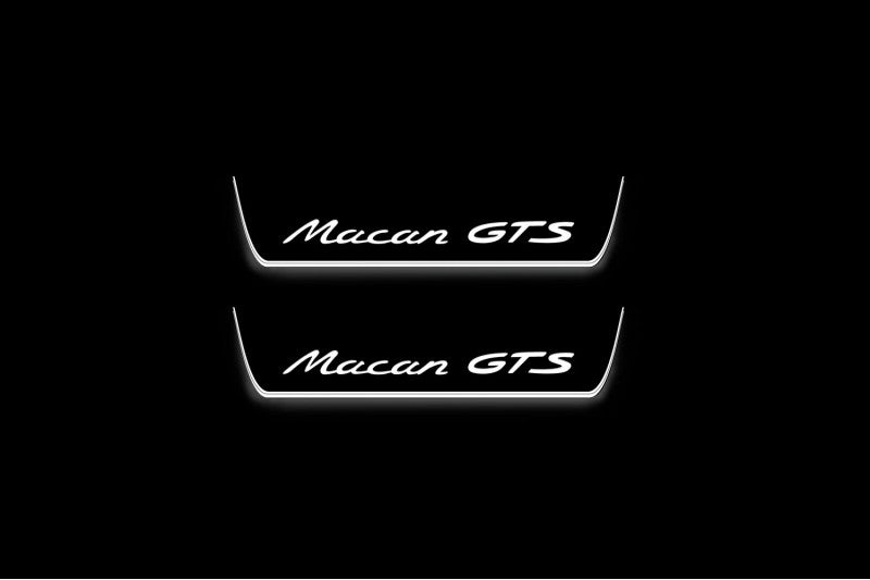 Two short door sill plates with Macan GTS lettering and edges illuminated in white, straight-on view on a dark background.