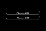 Two long door sill plates with Macan GTS lettering and edges illuminated in white, straight-on view on a dark background.