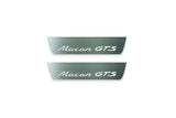 Two short silver-finished door sill plates with Macan GTS lettering on a light background, straight-on view.