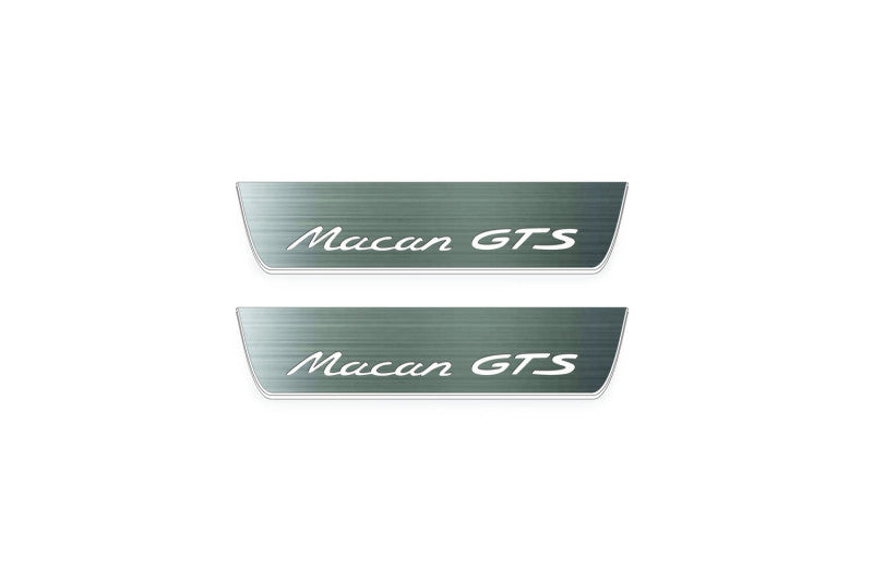 Two short silver-finished door sill plates with Macan GTS lettering on a light background, straight-on view.