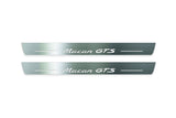 Two long silver-finished door sill plates with Macan GTS lettering on a light background, straight-on view.