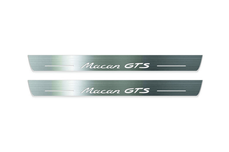 Two long silver-finished door sill plates with Macan GTS lettering on a light background, straight-on view.
