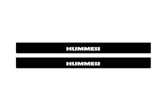 Catalog illustration of two black front door sill plates with Hummer lettering.