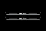 Two long door sill plates with Haval lettering and edges illuminated in white, straight-on view on a dark background.