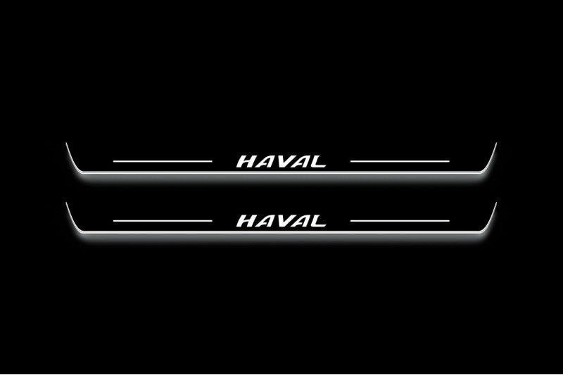 Two long door sill plates with Haval lettering and edges illuminated in white, straight-on view on a dark background.