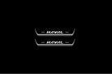 Two short door sill plates with Haval lettering and edges illuminated in white, straight-on view on a dark background.