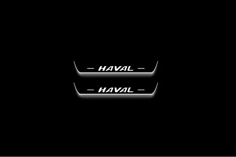 Two short door sill plates with Haval lettering and edges illuminated in white, straight-on view on a dark background.