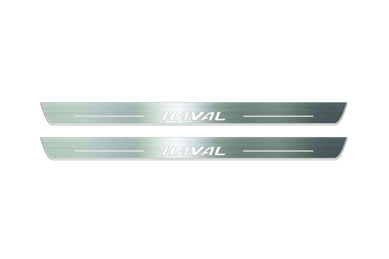 Two long silver-finished door sill plates with Haval lettering on a light background, straight-on view.