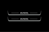 Two long door sill plates with Haval lettering and edges illuminated in white, straight-on view on a dark background.