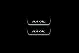 Two short door sill plates with Haval lettering and edges illuminated in white, straight-on view on a dark background.
