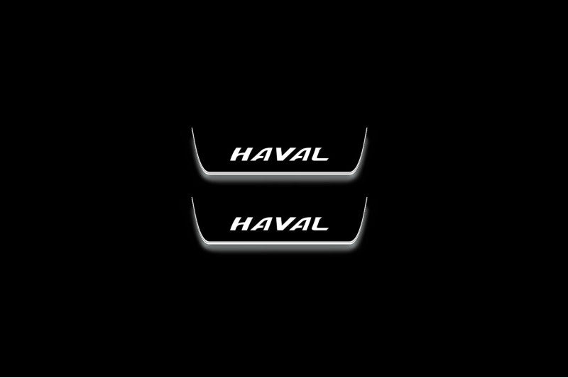 Two short door sill plates with Haval lettering and edges illuminated in white, straight-on view on a dark background.