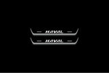 Two short door sill plates with Haval lettering and edges illuminated in white, straight-on view on a dark background.