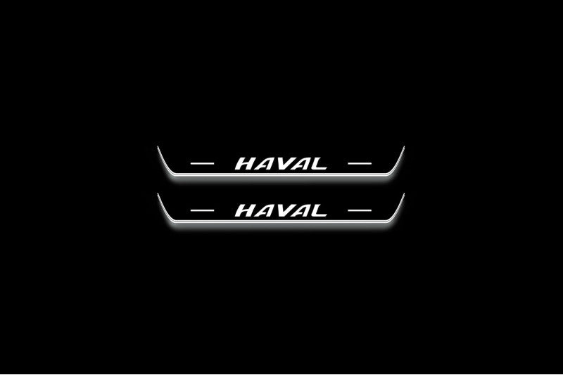 Two short door sill plates with Haval lettering and edges illuminated in white, straight-on view on a dark background.