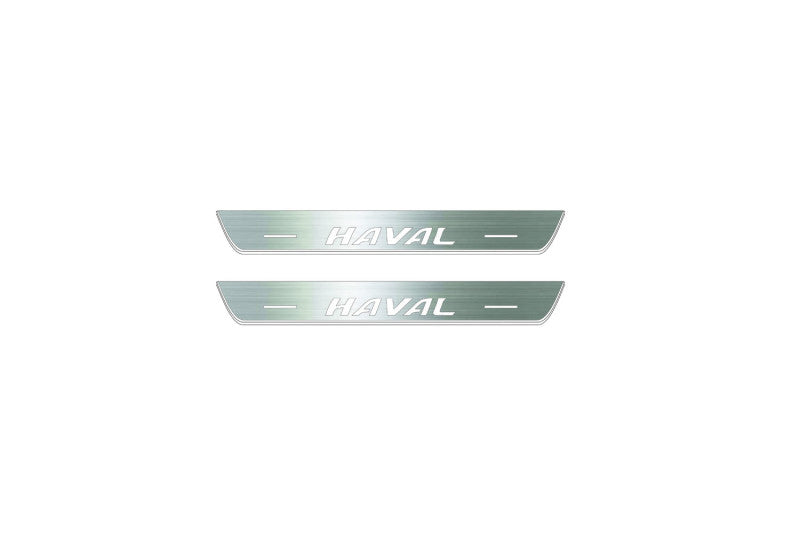 Two short silver-finished door sill plates with Haval lettering on a light background, straight-on view.