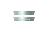 Two short silver-finished door sill plates with Hennessey lettering on a light background, straight-on view.