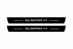 Catalogue illustration of two front black Matte PRO LED door sill plates with illuminated Elantra GT lettering for Hyundai Elantra GT; dimensions are selected during manufacture.