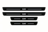 Shared catalogue illustration of two long front and two shorter rear black Matte PRO plates with illuminated i20 lettering and unlit edges. FRONT option contains only front pair; Hyundai i20 PB dimensions are selected during manufacture.