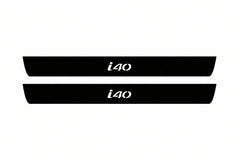 Catalogue illustration of two front black Matte PRO LED door sill plates with illuminated i40 lettering for Hyundai i40; dimensions are selected during manufacture.