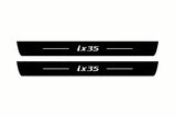 Catalogue illustration of two front black Matte PRO LED door sill plates with illuminated ix35 lettering for Hyundai ix35; dimensions are selected during manufacture.