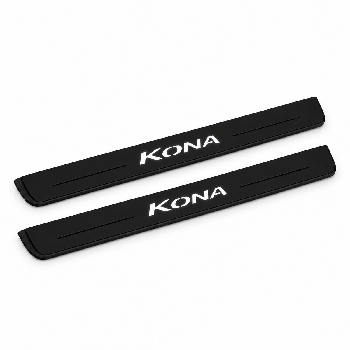 Catalogue illustration of two black Matte PRO front door sill plates with illuminated KONA lettering on the top surface. Edges are unlit; rear plates for FRONT+REAR are not pictured. Final dimensions are selected for Hyundai Kona OS during manufacture.