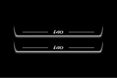 Two long door sill plates with i40 lettering and edges illuminated in white, straight-on view on a dark background.