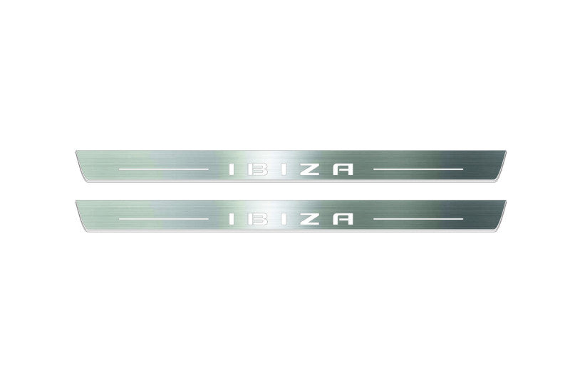 Two long silver-finished door sill plates with Ibiza in block lettering lettering on a light background, straight-on view.