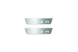 Two short silver-finished door sill plates with Ibiza in block lettering lettering on a light background, straight-on view.