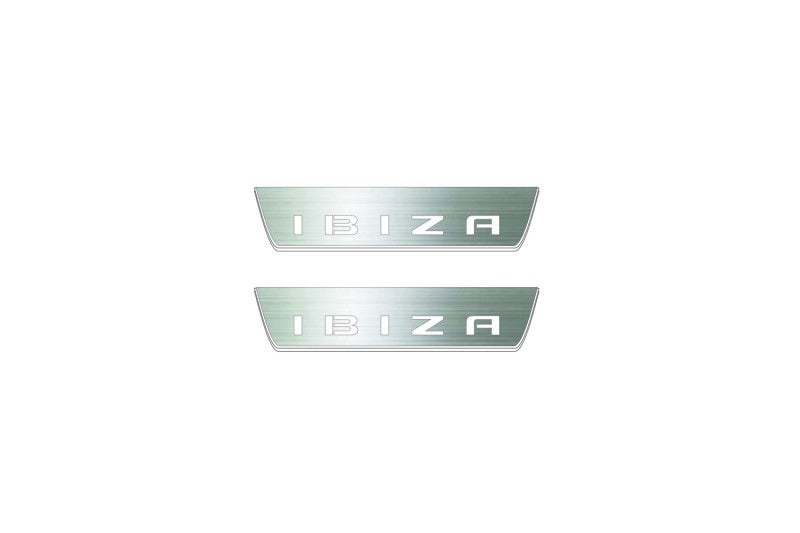 Two short silver-finished door sill plates with Ibiza in block lettering lettering on a light background, straight-on view.