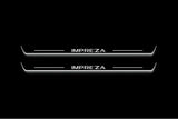 Two long door sill plates with Impreza lettering and edges illuminated in white, straight-on view on a dark background.