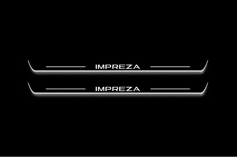 Two long door sill plates with Impreza lettering and edges illuminated in white, straight-on view on a dark background.