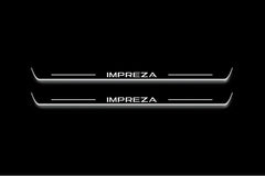 Two long door sill plates with Impreza lettering and edges illuminated in white, straight-on view on a dark background.