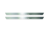 Two long silver-finished door sill plates with Impreza lettering on a light background, straight-on view.
