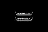 Two short door sill plates with Impreza lettering and edges illuminated in white, straight-on view on a dark background.