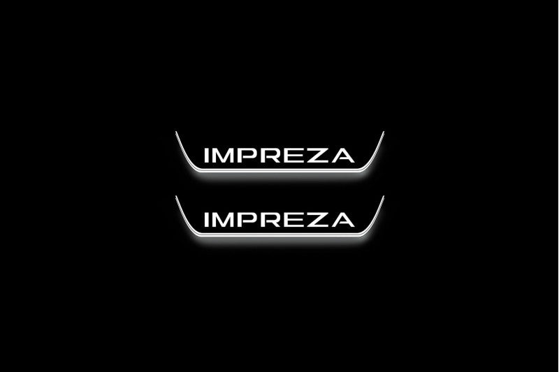 Two short door sill plates with Impreza lettering and edges illuminated in white, straight-on view on a dark background.