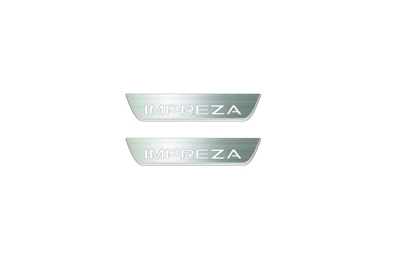 Two short silver-finished door sill plates with Impreza lettering on a light background, straight-on view.