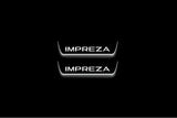 Two short door sill plates with Impreza lettering and edges illuminated in white, straight-on view on a dark background.