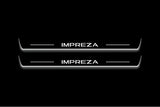Two long door sill plates with Impreza lettering and edges illuminated in white, straight-on view on a dark background.